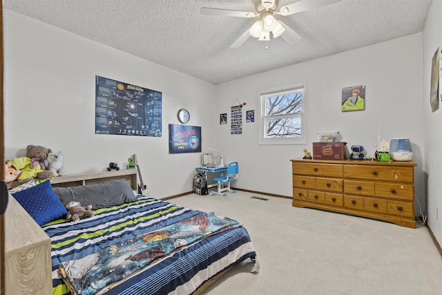 bedroom featuring a textured ceiling, carpet floors, and ceiling fan