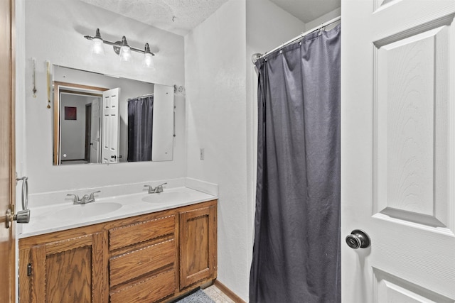 bathroom with vanity and a textured ceiling