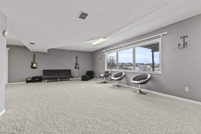 workout area with carpet floors and a textured ceiling