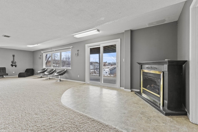 interior space featuring light carpet and a textured ceiling