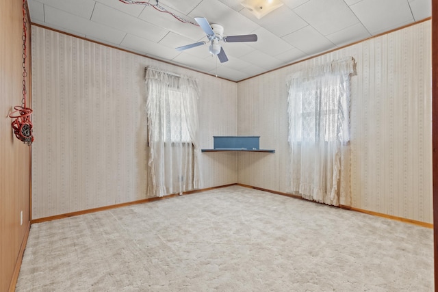 carpeted spare room featuring ceiling fan