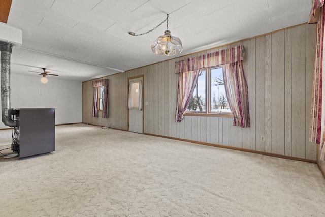 interior space with carpet floors and ceiling fan