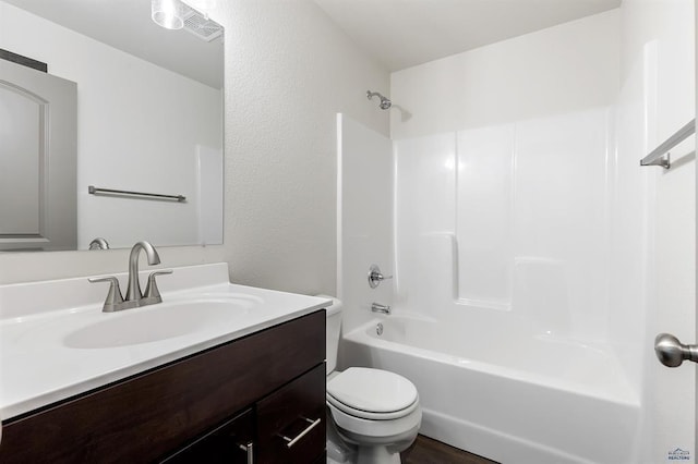 full bathroom featuring hardwood / wood-style flooring, vanity, toilet, and shower / washtub combination