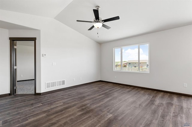 empty room featuring ceiling fan, dark hardwood / wood-style floors, and vaulted ceiling