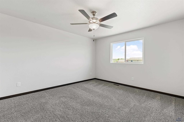 unfurnished room with ceiling fan and carpet