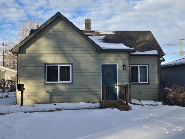 view of snow covered back of property