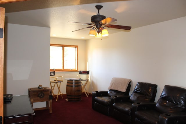 carpeted living area featuring ceiling fan