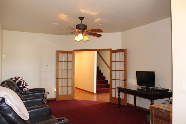 living area with stairway, a ceiling fan, carpet, baseboards, and french doors