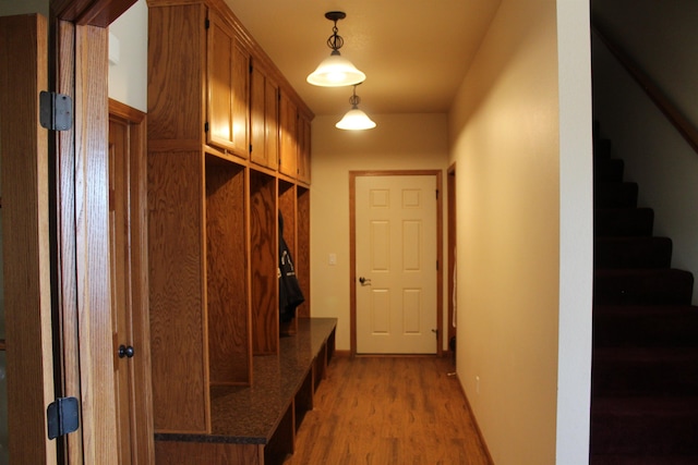 mudroom featuring light wood-style flooring and baseboards