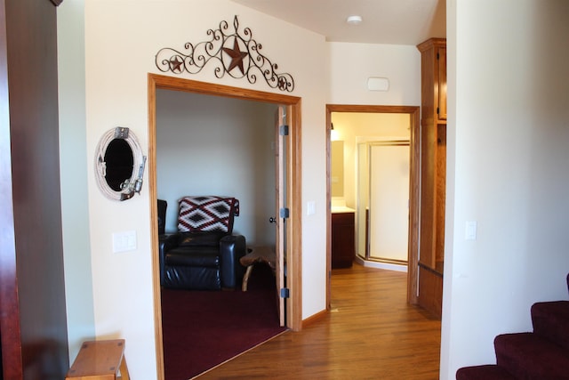 corridor featuring stairway and wood finished floors