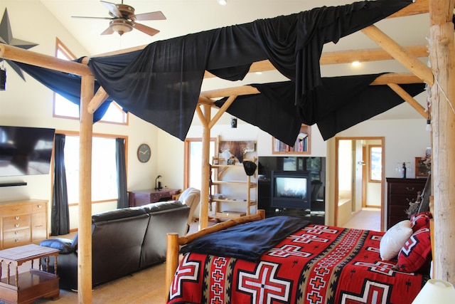 bedroom with a multi sided fireplace, multiple windows, and high vaulted ceiling