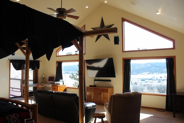 carpeted living room with baseboards, high vaulted ceiling, and a ceiling fan