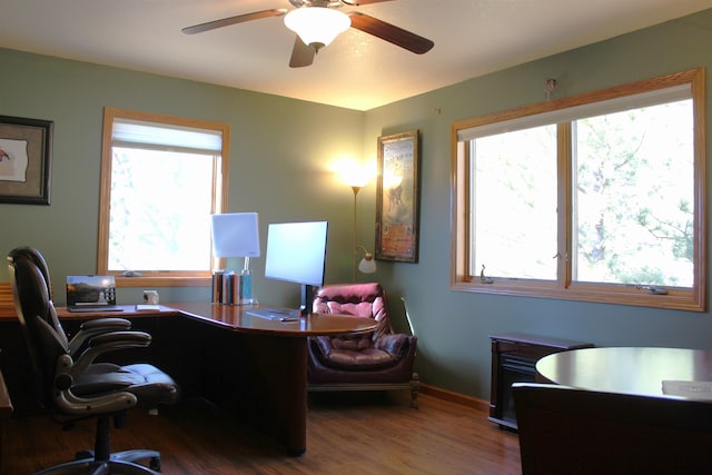 office space featuring baseboards, a ceiling fan, and wood finished floors