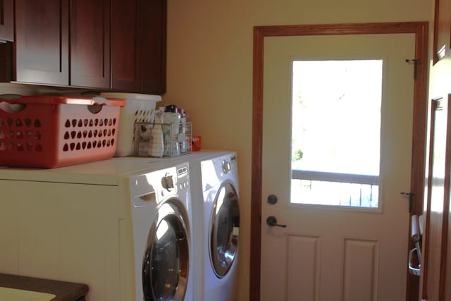 clothes washing area with cabinet space and separate washer and dryer