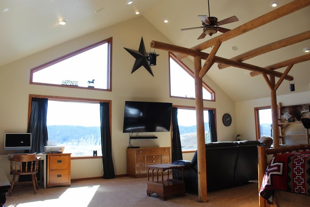 carpeted living area featuring a ceiling fan, baseboards, and high vaulted ceiling