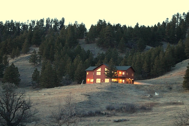 exterior space featuring a view of trees and a detached garage