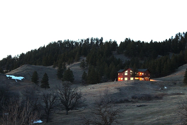 exterior space featuring a wooded view