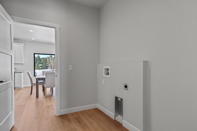 laundry room with hookup for a washing machine, hookup for an electric dryer, and light wood-type flooring