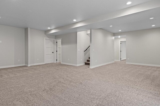 basement featuring light carpet