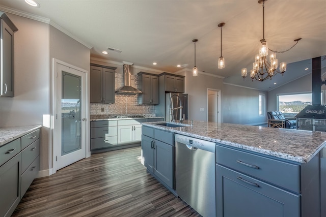 kitchen featuring decorative backsplash, hanging light fixtures, a large island, stainless steel appliances, and wall chimney range hood