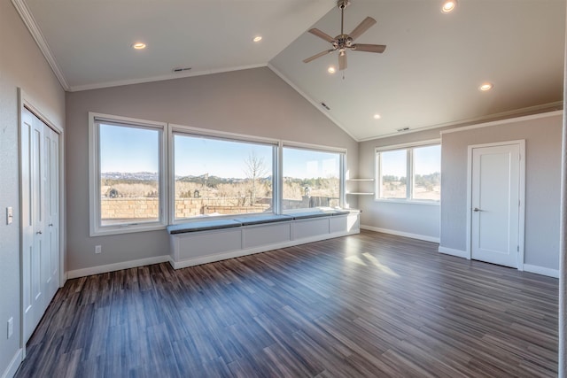 unfurnished living room with dark hardwood / wood-style flooring, vaulted ceiling, ornamental molding, and ceiling fan