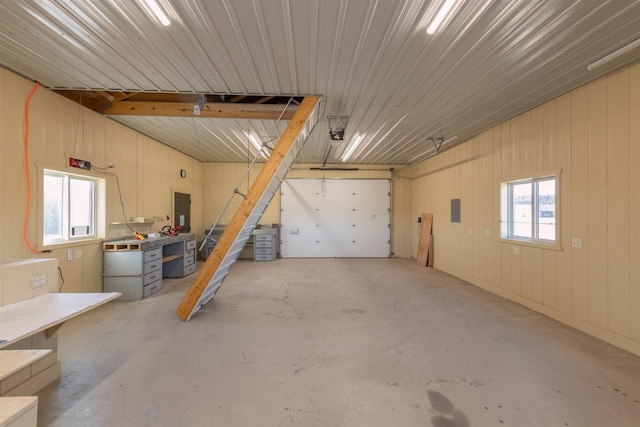 garage with electric panel and a workshop area