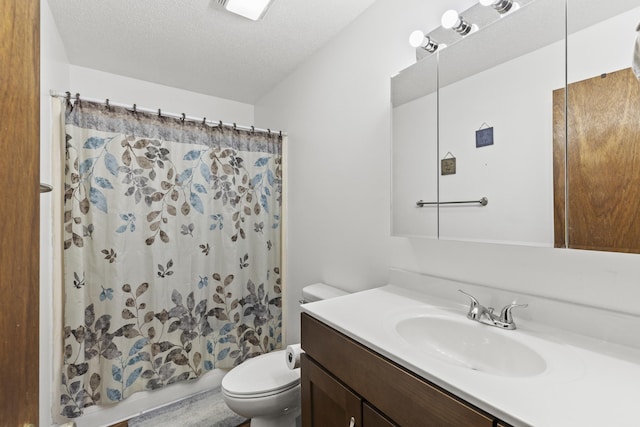 bathroom featuring vanity, a shower with curtain, toilet, and a textured ceiling