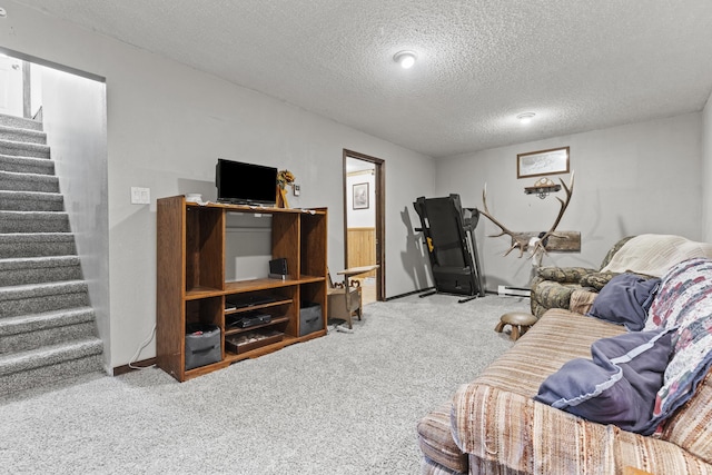 living room featuring baseboard heating, a textured ceiling, and carpet flooring