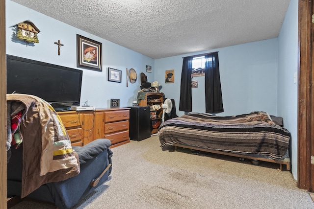 bedroom with light colored carpet and a textured ceiling