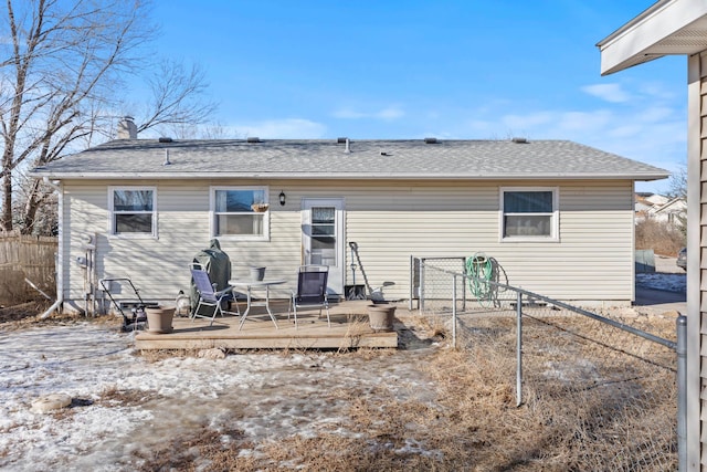 back of property with a wooden deck