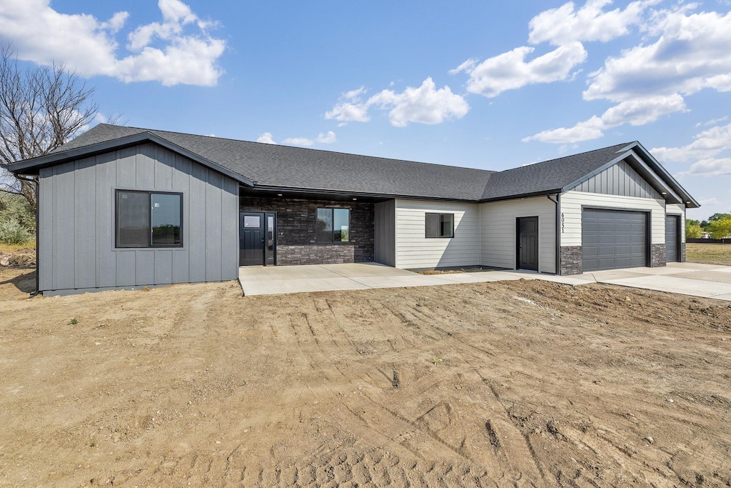 view of front of house featuring a garage and a patio