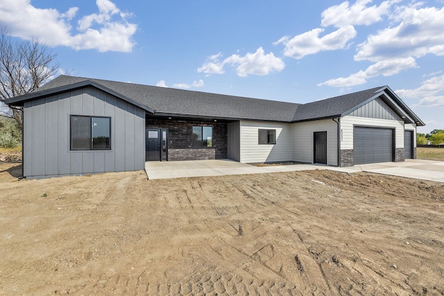 view of front of house featuring a garage and a patio