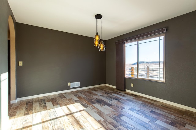 empty room featuring dark hardwood / wood-style flooring