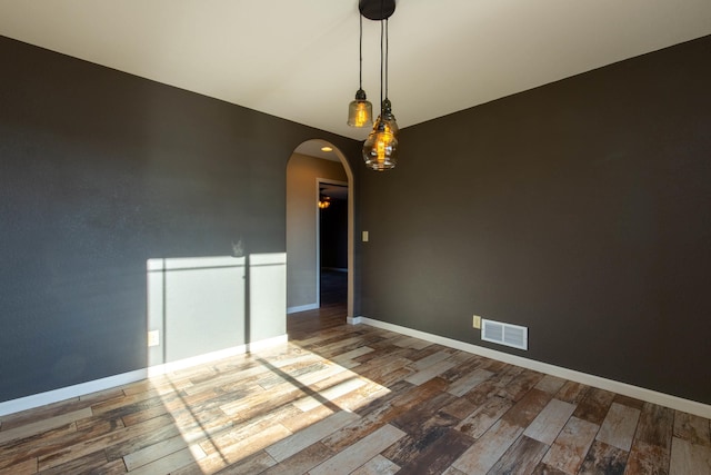 empty room featuring wood-type flooring