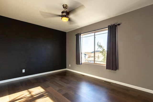 spare room featuring ceiling fan and dark hardwood / wood-style flooring