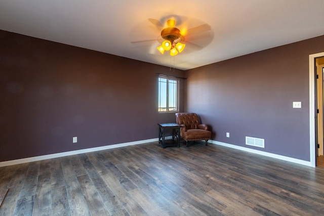 unfurnished room with ceiling fan and dark hardwood / wood-style flooring