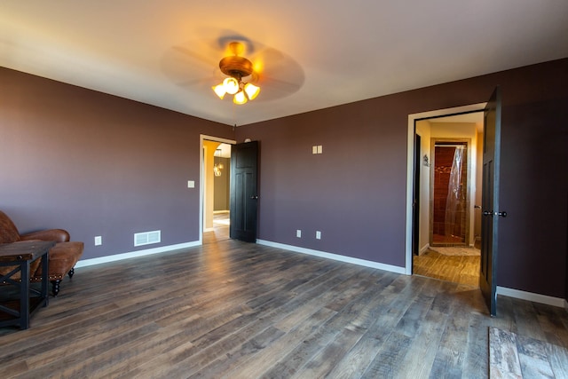 unfurnished bedroom with dark wood-type flooring and ceiling fan