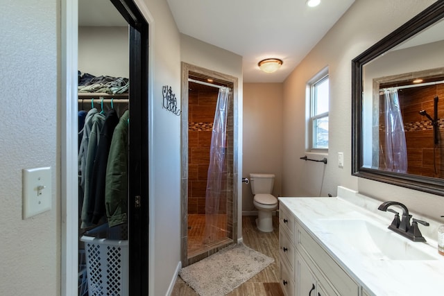 bathroom featuring vanity, toilet, hardwood / wood-style floors, and a shower with shower curtain