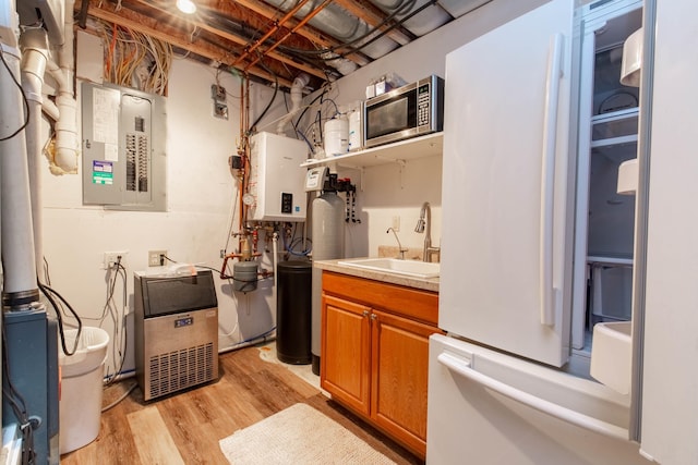 interior space featuring sink, electric panel, and tankless water heater