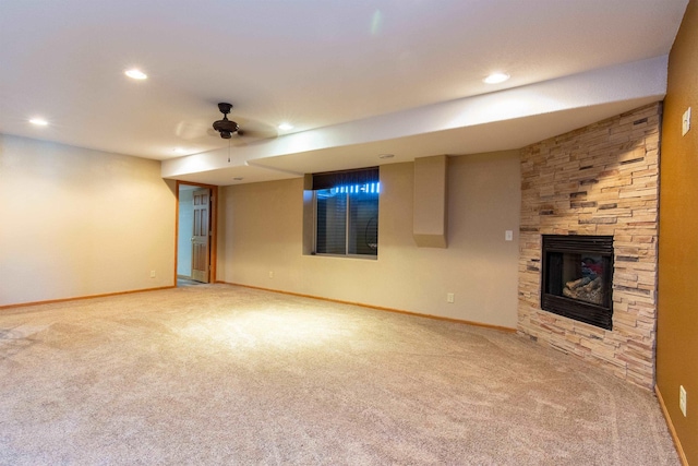 unfurnished living room with ceiling fan, carpet flooring, and a fireplace