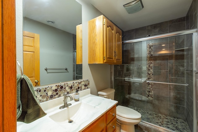 bathroom with vanity, an enclosed shower, and toilet