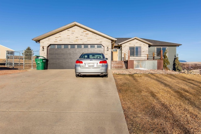 view of front of house featuring a garage and a front yard