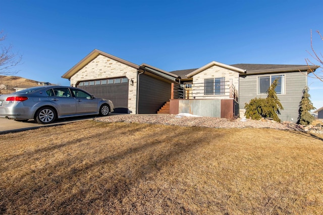 single story home with a garage and a front yard