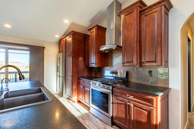 kitchen with sink, wall chimney range hood, light wood-type flooring, stainless steel appliances, and backsplash