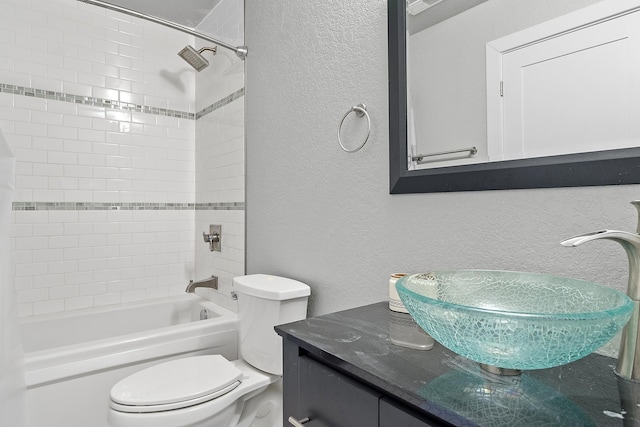 full bathroom featuring vanity, toilet, and tiled shower / bath combo