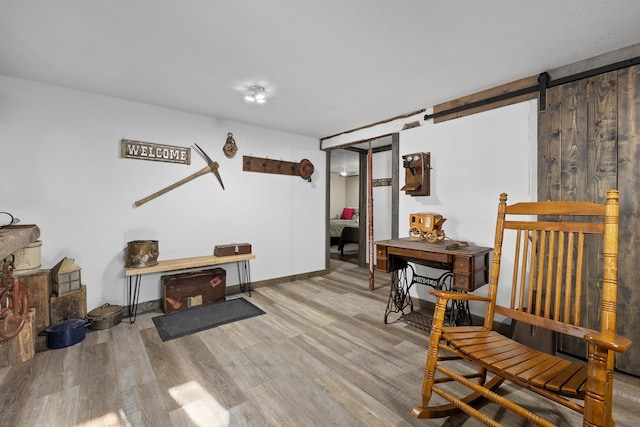 sitting room featuring hardwood / wood-style flooring and a barn door