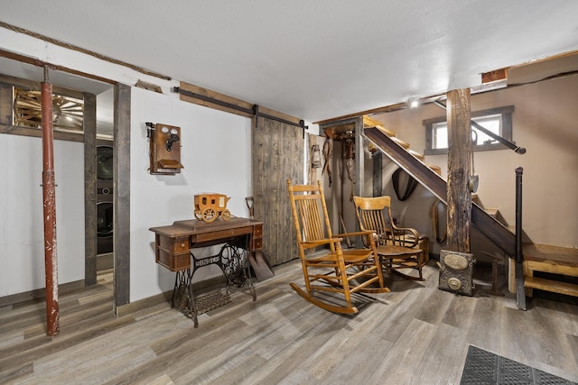 living area with hardwood / wood-style floors and a barn door