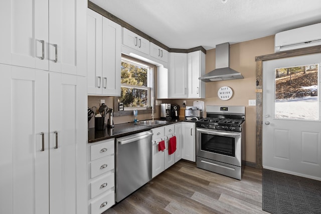 kitchen featuring wall chimney exhaust hood, sink, dark hardwood / wood-style floors, stainless steel appliances, and white cabinets