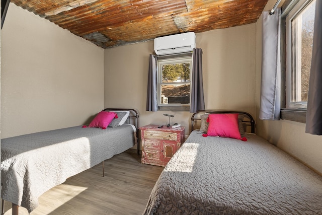 bedroom featuring hardwood / wood-style floors, wooden ceiling, and an AC wall unit