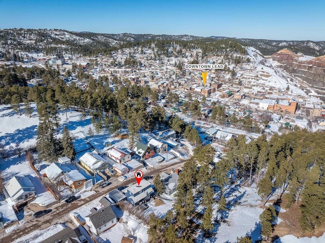 snowy aerial view with a mountain view